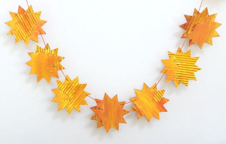 an orange and yellow star garland on a white background