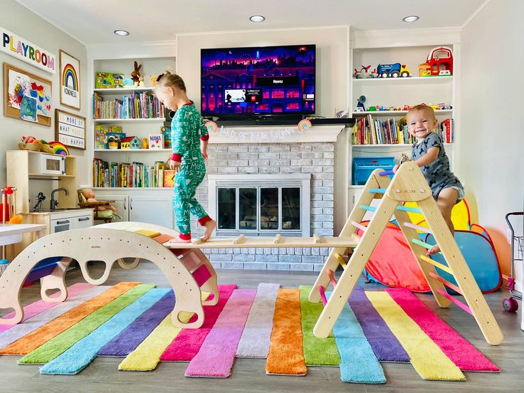 two children playing in a play room with colorful rugs