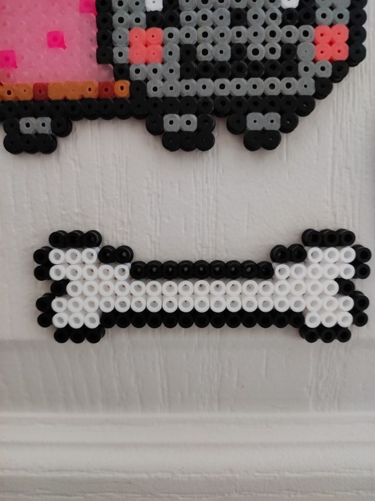 some type of bead art hanging on the wall