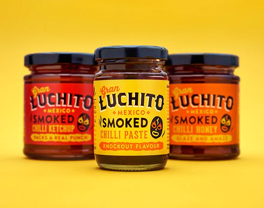 three jars of smoked chili paste on a yellow background