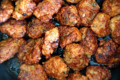 some fried food is being cooked in a pan