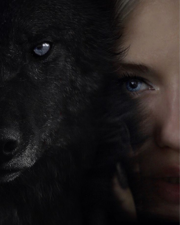 a woman with blue eyes is next to a wolf