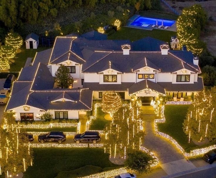 an aerial view of a house with christmas lights on the front and side of it