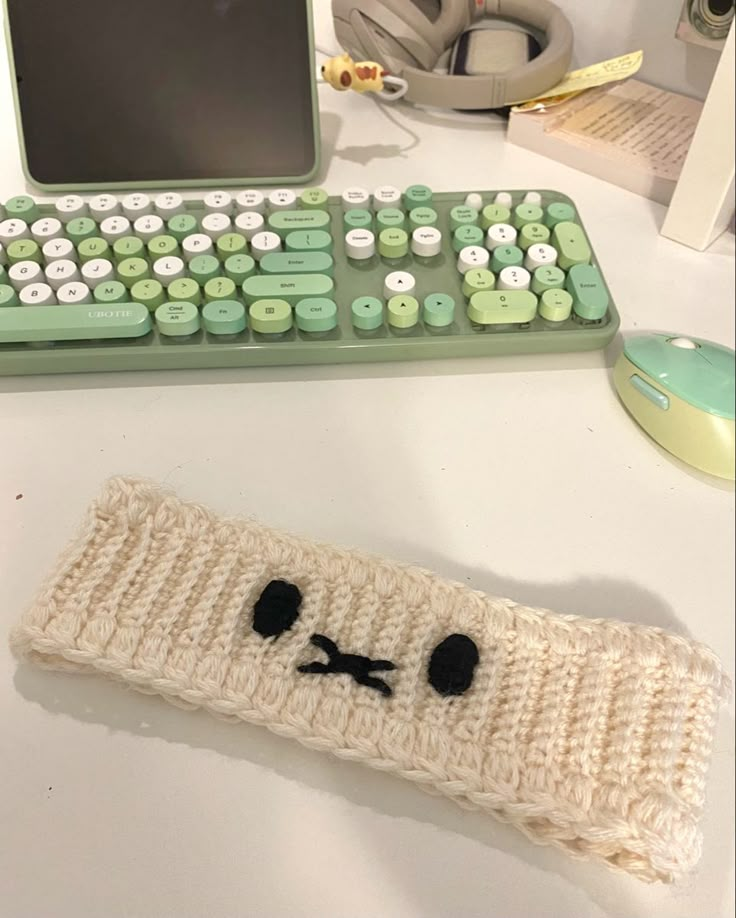 a crocheted keyboard and mouse pad sitting on a desk