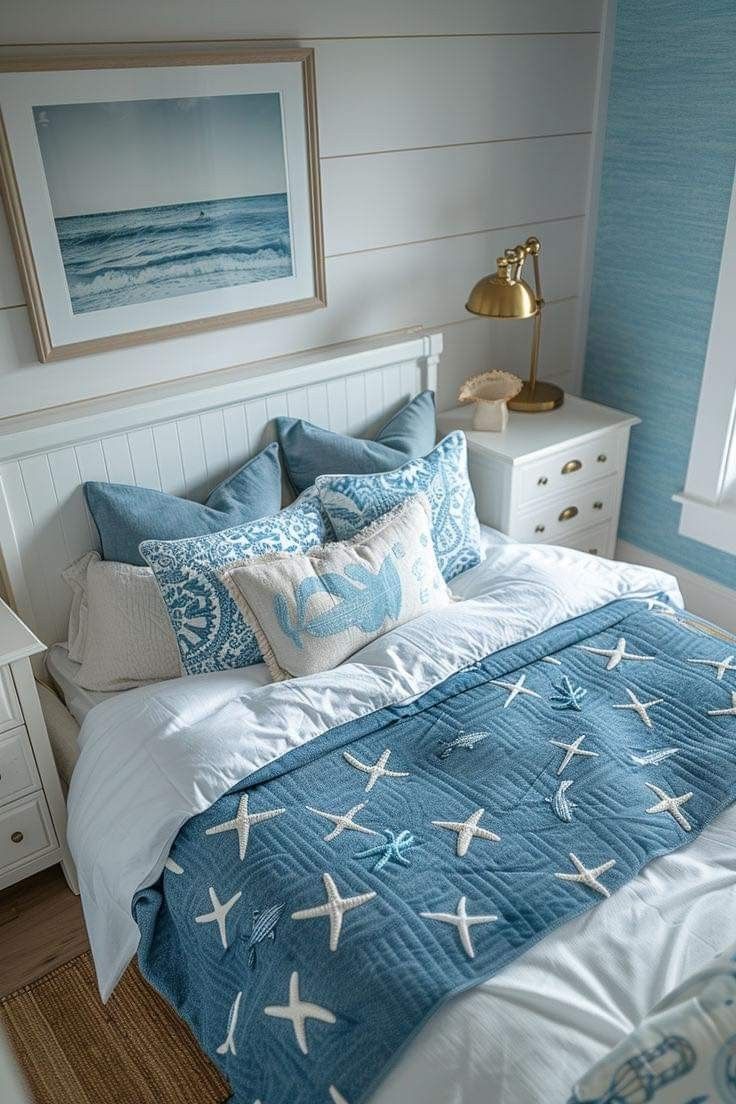 a bed with blue and white comforter in a bedroom