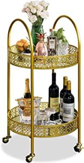 a gold metal bar cart with wine bottles and glasses on the bottom shelf next to flowers