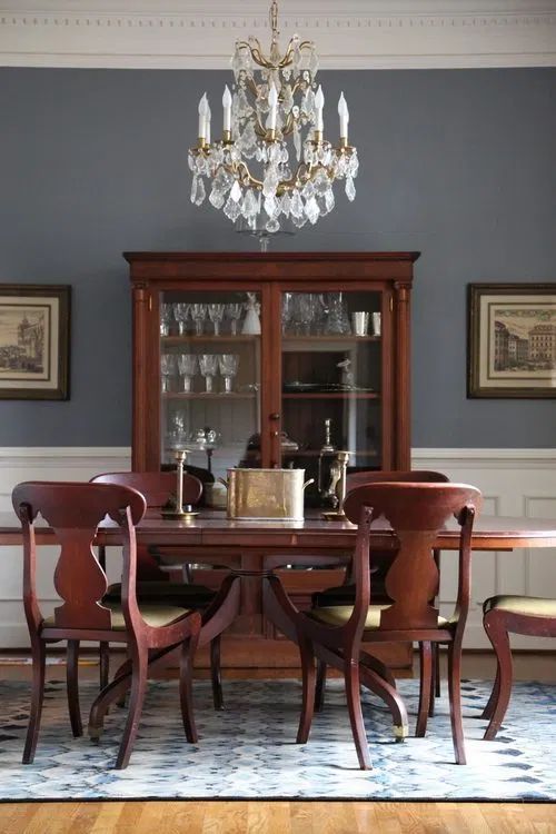 a dining room table with chairs and a chandelier