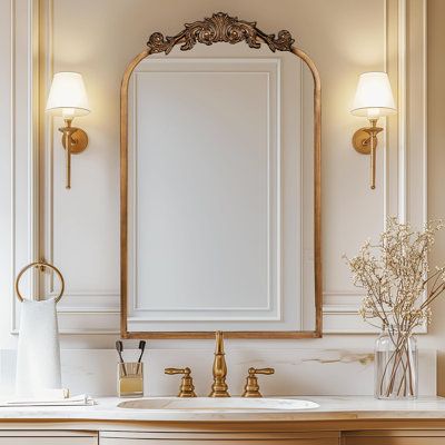 a bathroom vanity with a large mirror above it and two lights on either side of the sink