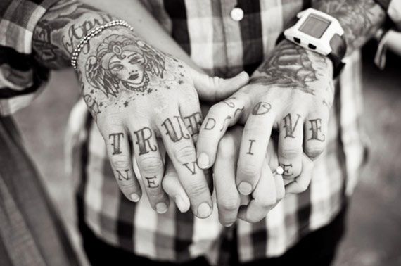 two tattooed hands holding each other with the words true love written on them and an apple watch