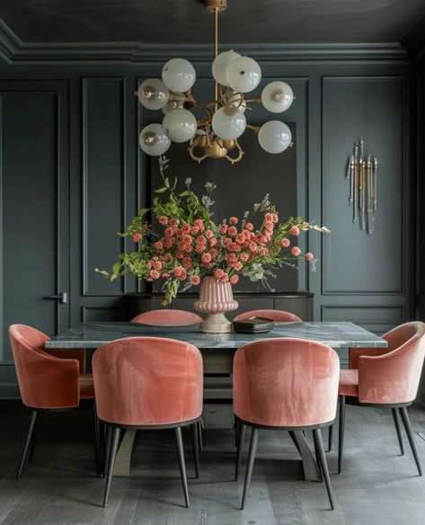 a dining room table with pink chairs and a chandelier