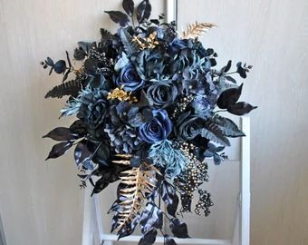 a bouquet of blue flowers sitting on top of a white chair