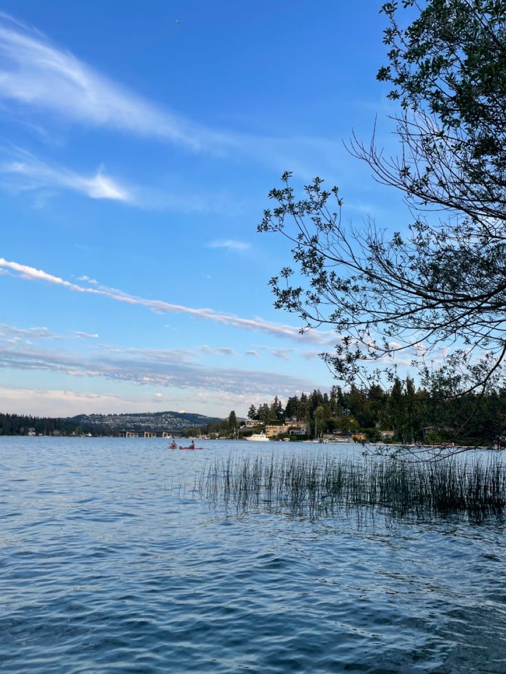 the water is calm and blue with some clouds in the sky