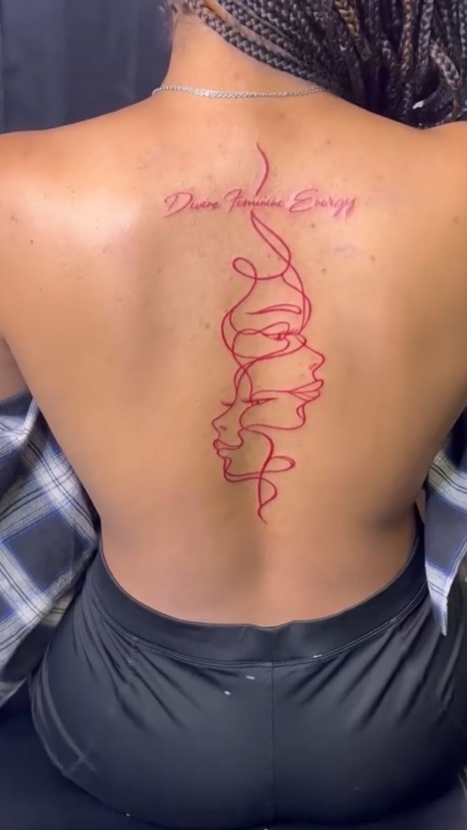 the back of a woman's body with red ink on her upper and lower back