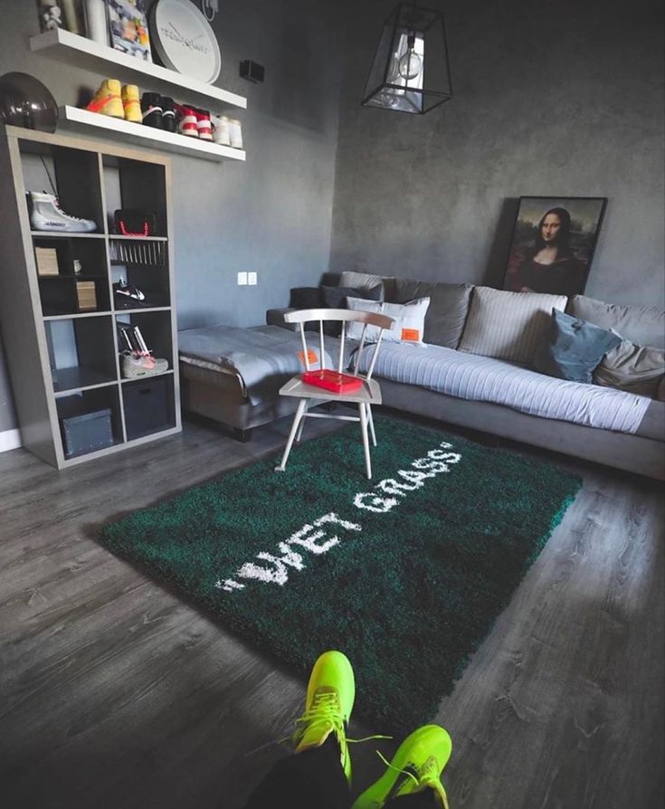 a living room with a green rug that says welcome home