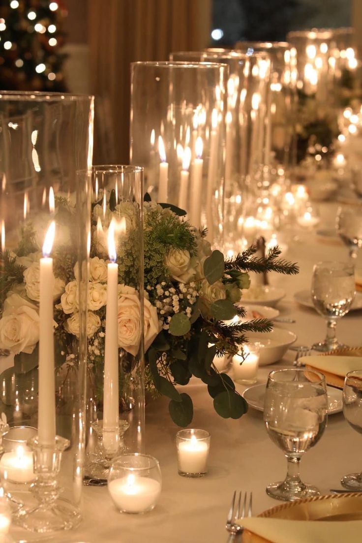 the table is set with candles, flowers and place settings for an elegant dinner party