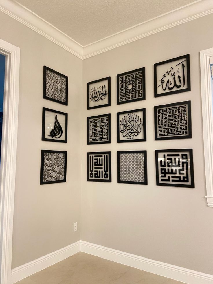 there are nine framed pictures on the wall in this room, and one is black and white