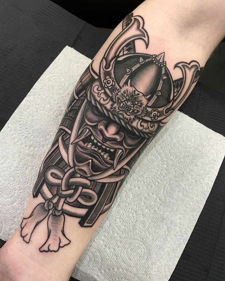 a man's arm with a tattoo on it that has an image of a skull wearing a crown