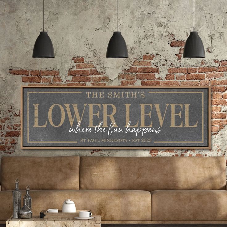 a couch in front of a brick wall with the words lower level written on it