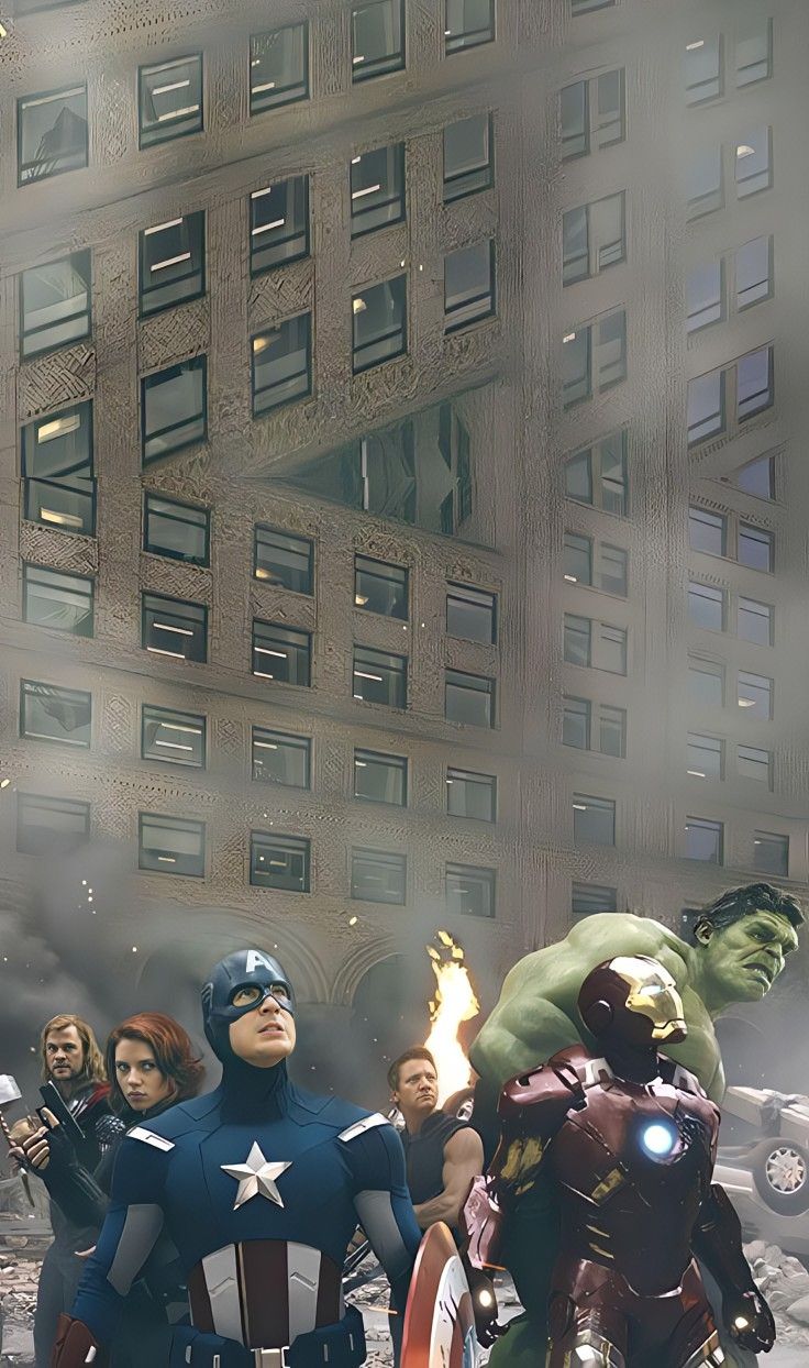 the avengers are standing in front of a building