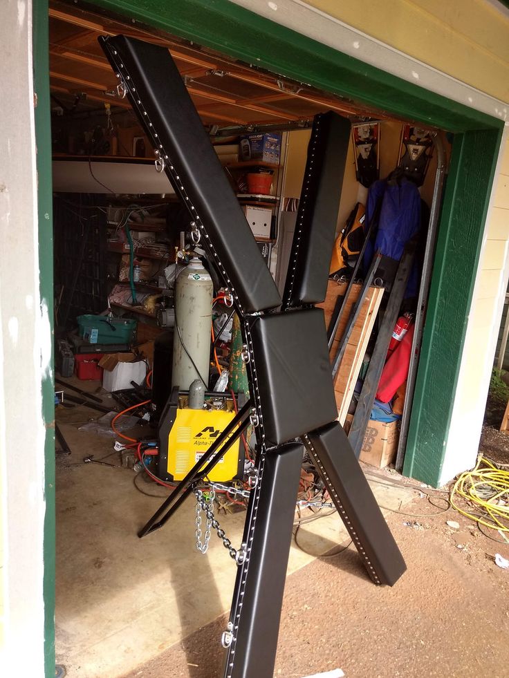 a large metal object sitting in the middle of a garage floor next to a building