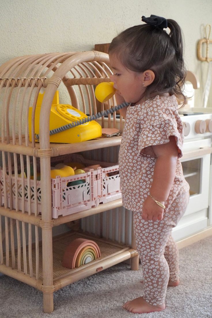 Display your little one's favorite books and toys. Montessori-style shelves make it easy for them to reach! Made of sustainably sourced and renewable rattanCoated in a natural water-based finishHeight: 28.0"Width: 16.0"Depth: 12.0"Final Sale Item Kids Room Toy Storage Baby, Kids Montessori Shelf, Playroom Color Scheme, Shelf Measurements, Rattan Shelf, Montessori Bookshelf, Toddler Playground, Rattan Cabinet, Montessori Shelf