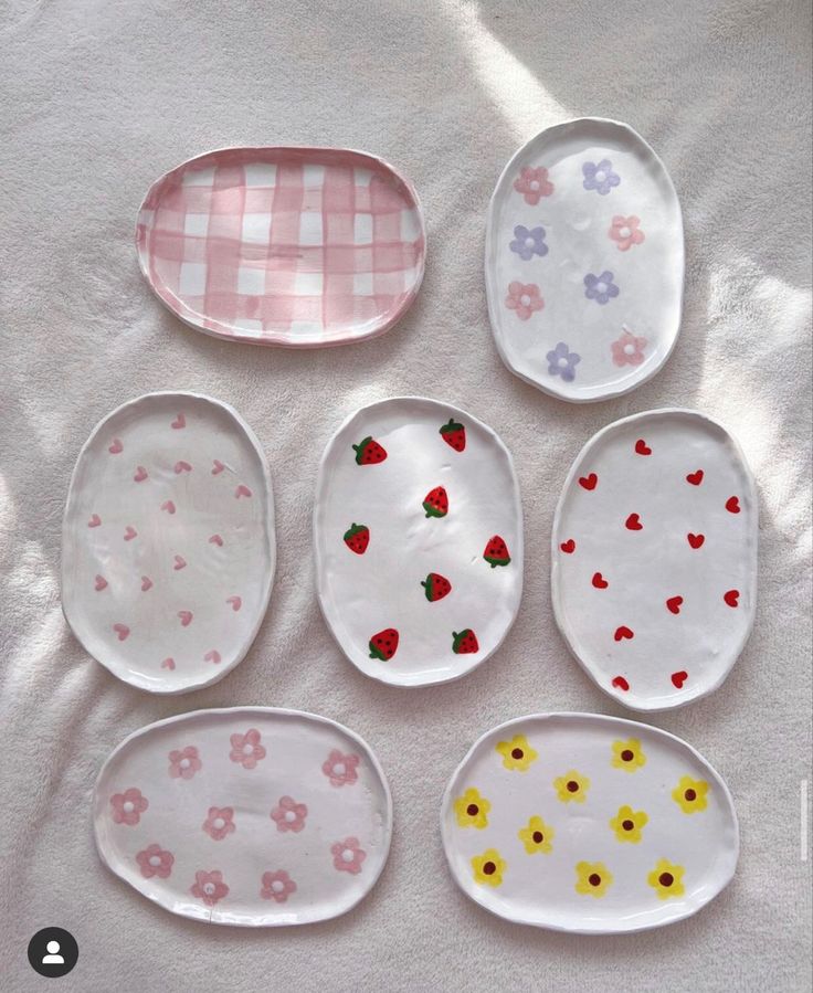 six plates with different designs on them sitting on a table