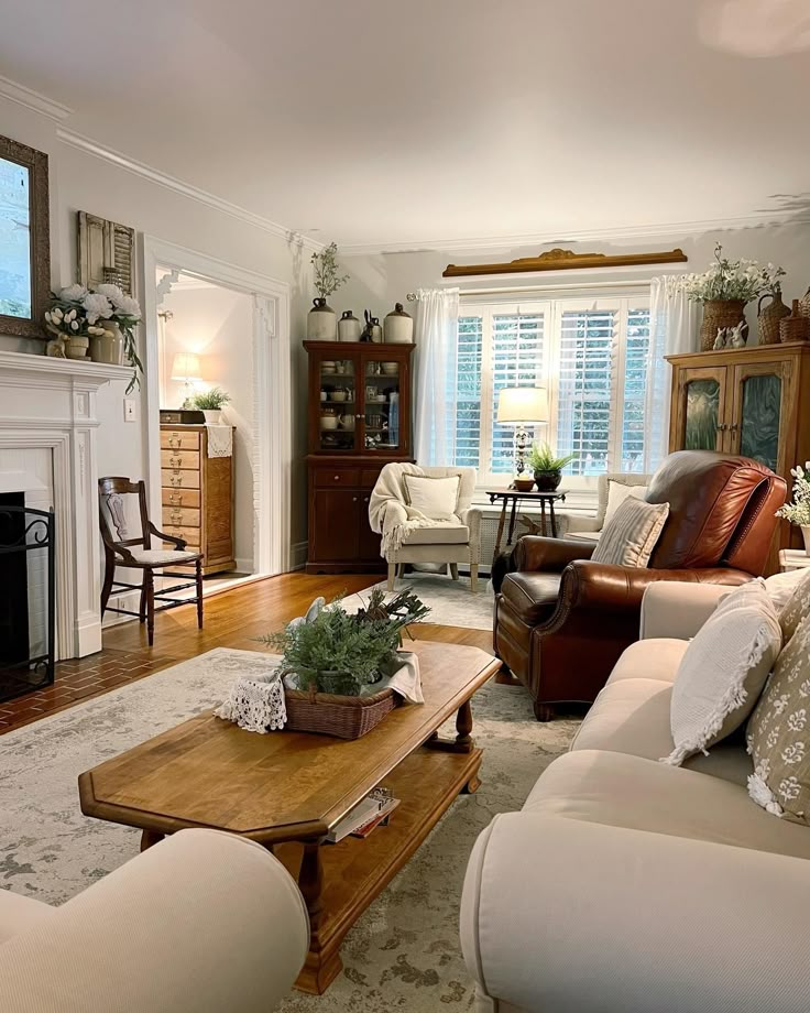 a living room filled with furniture and a fire place in the middle of a room