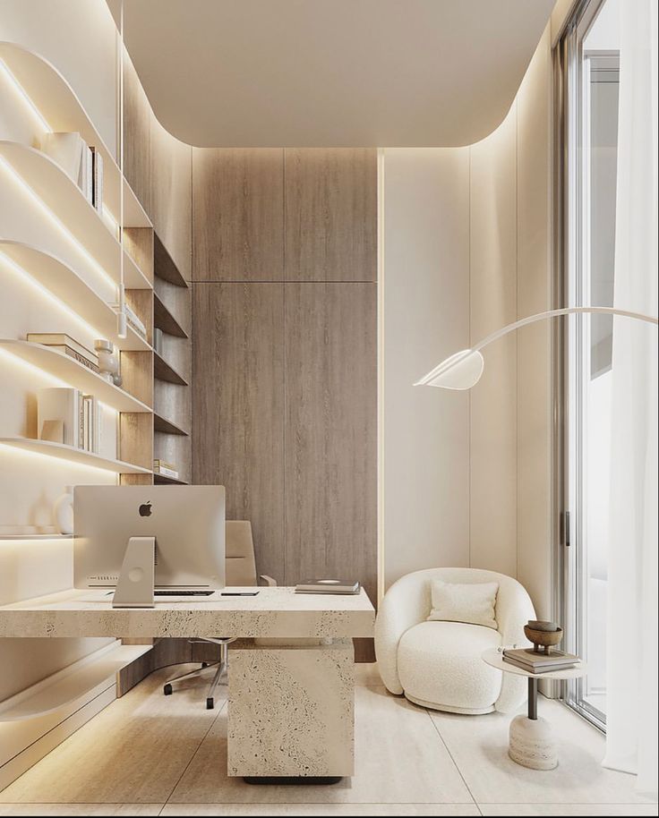 an office with a desk, chair and bookshelf on the wall is lit by recessed lights