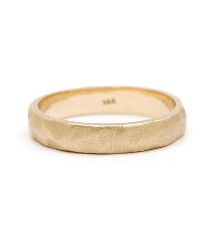 a yellow gold wedding ring on a white background