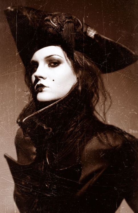 a woman wearing a black hat and coat