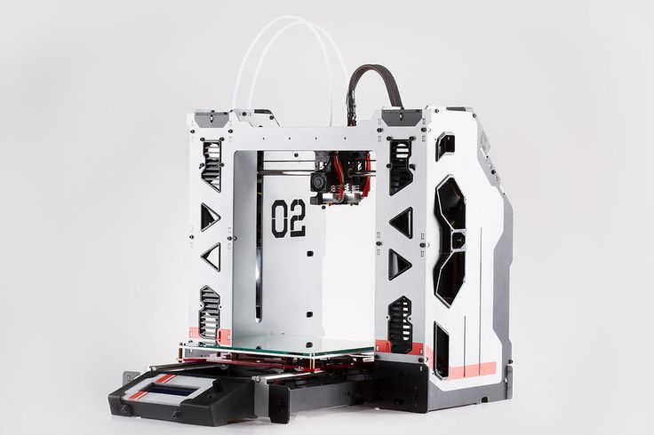 a white and black 3d printer sitting on top of a table