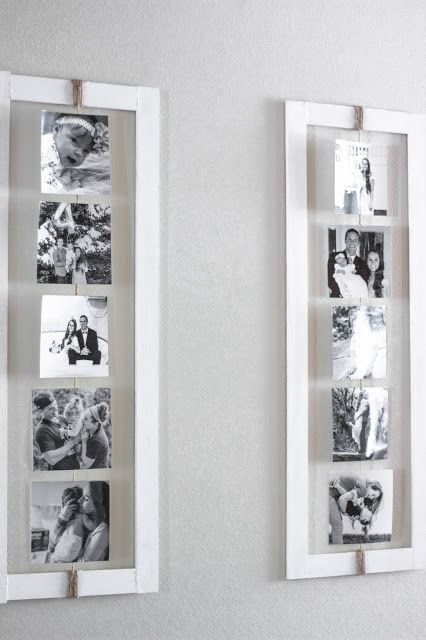 two white framed pictures hanging on the wall with clothes pins attached to them, one is holding a wedding photo