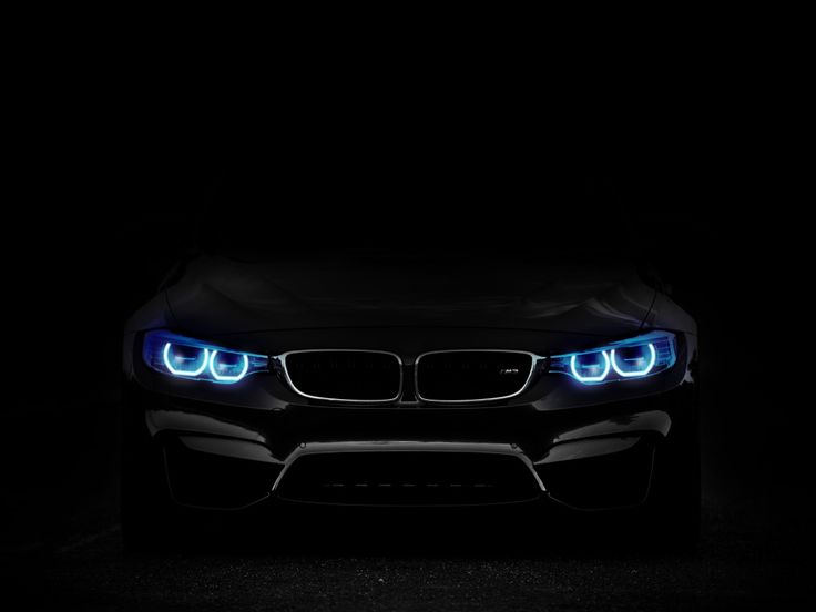 the front end of a black car with blue lights