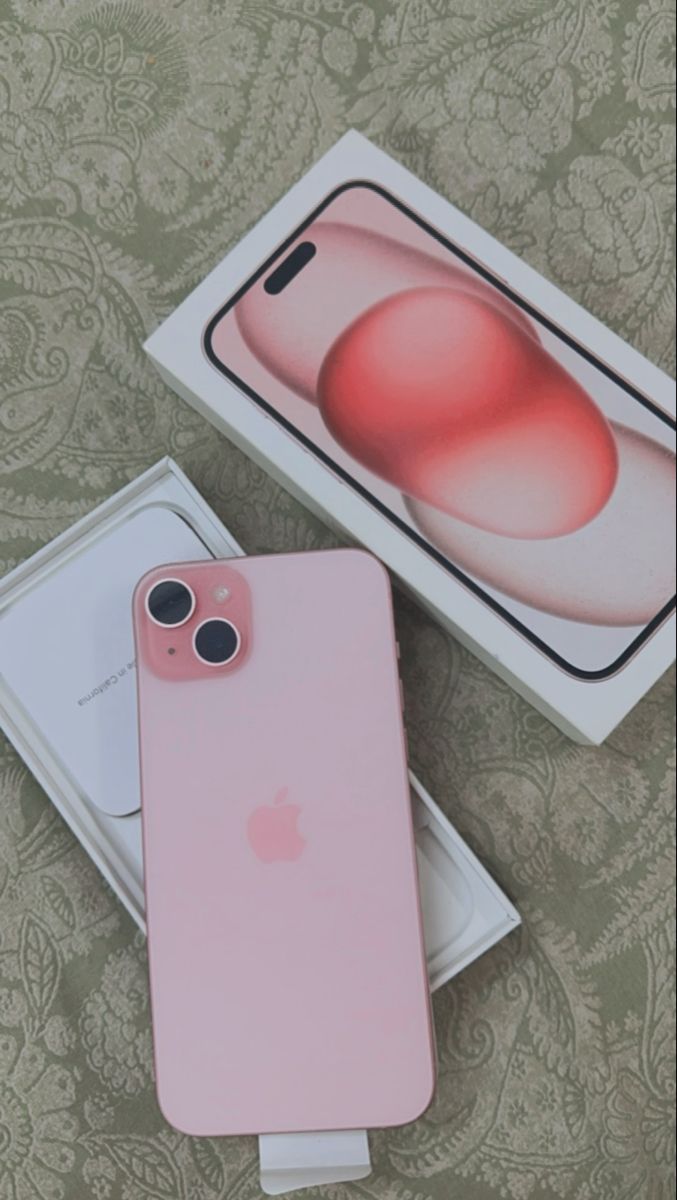 the pink iphone 11 is next to its box