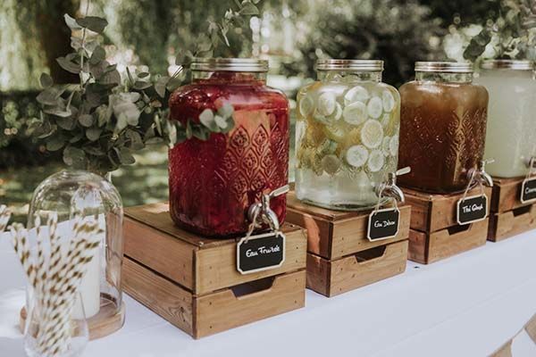 mason jars with labels are lined up on a table