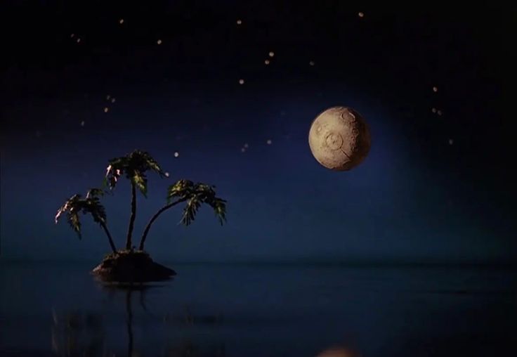 a small island with two palm trees in the middle and a moon above it at night