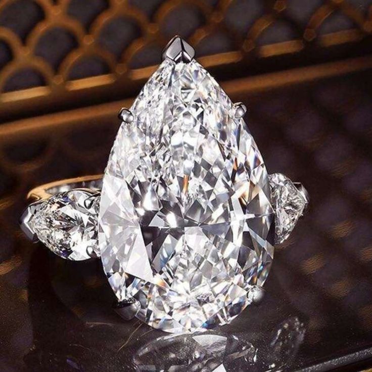 a large diamond ring sitting on top of a table