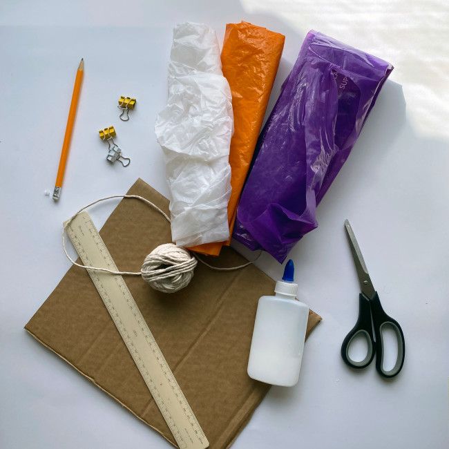 the supplies needed to make an ornament are laid out on top of a piece of cardboard