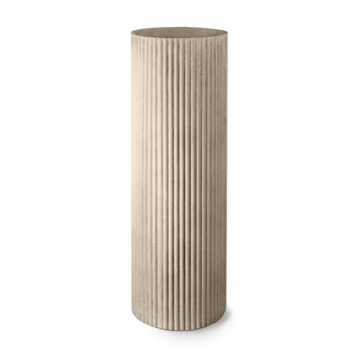 a tall white vase sitting on top of a table