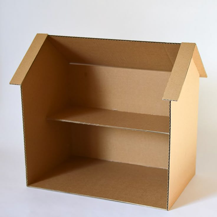 an open cardboard box sitting on top of a white table with no one in it