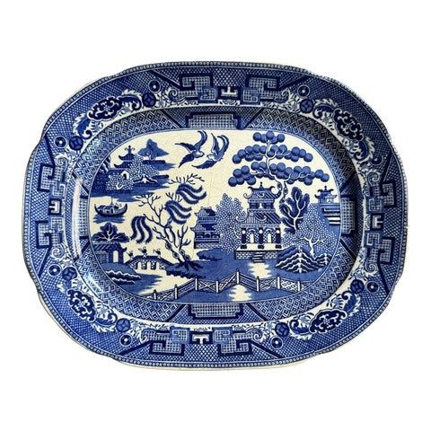 a blue and white platter with an image of a horse in the woods on it