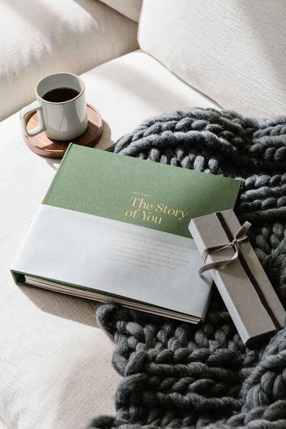 the story of you book and wrapped present sitting on a couch with a cup of coffee