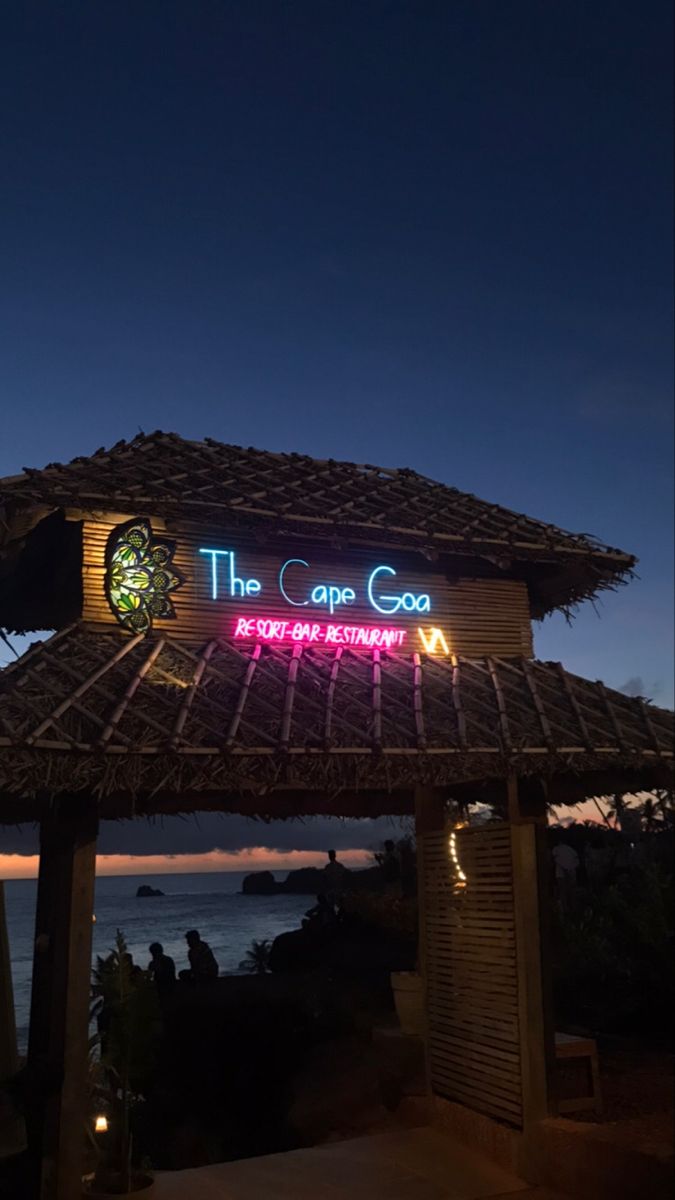 a tiki hut lit up at night with the caption the cana co