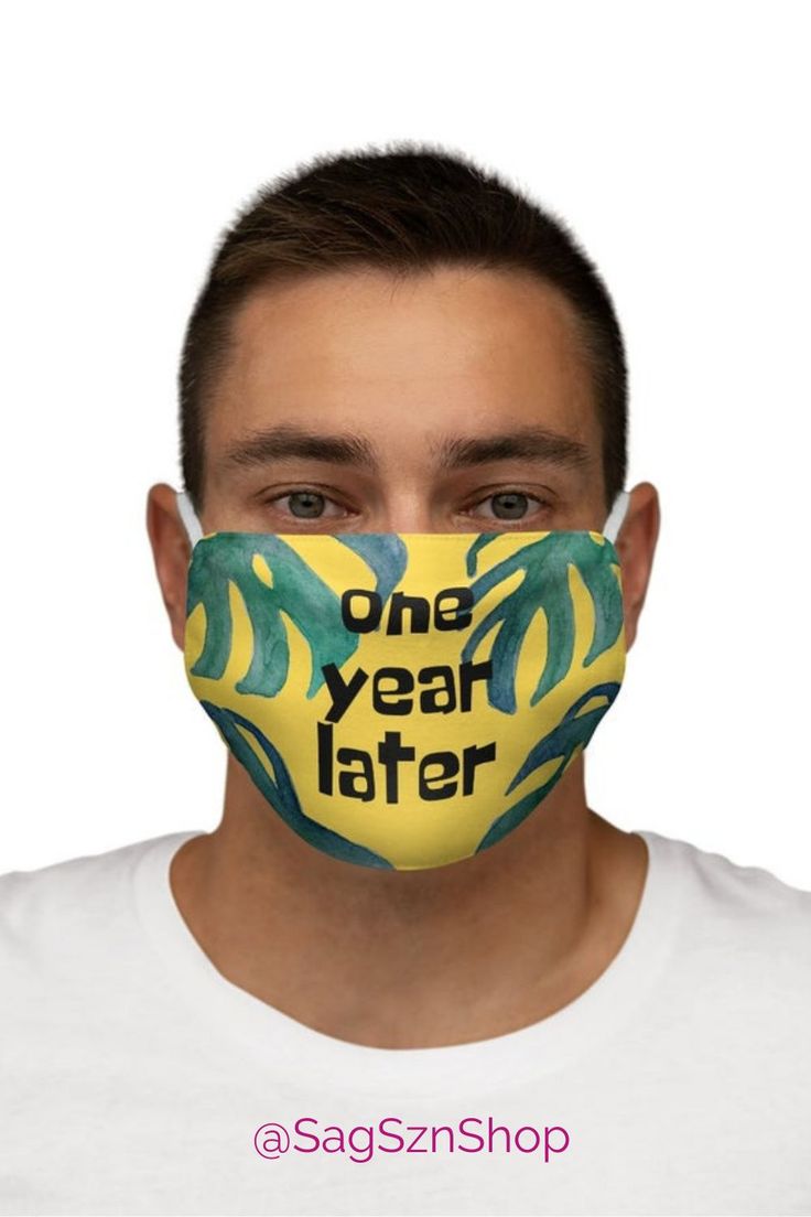 a man wearing a face mask with the words one year later printed on it