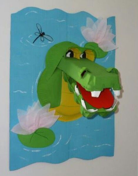 a paper cut out of an alligator with flowers on it