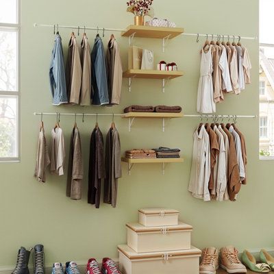 a closet with shoes and clothes hanging on the wall