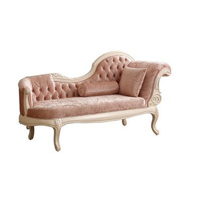 a pink couch sitting on top of a white floor