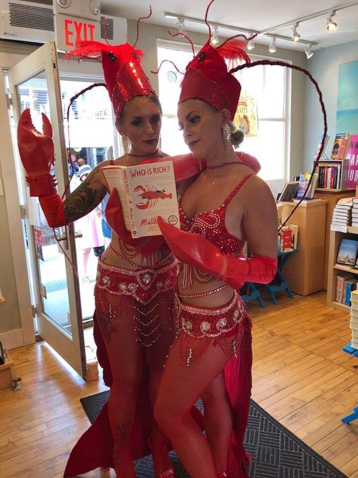 two women in red costumes are standing next to each other