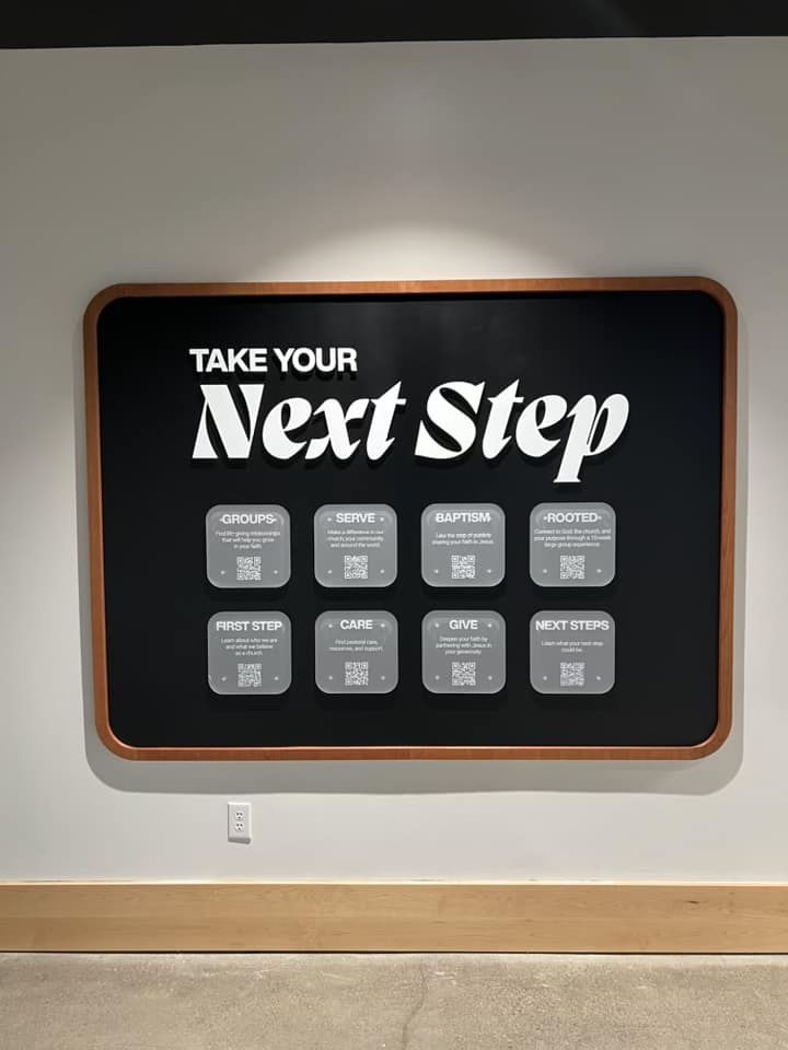 there is a sign that says take your next step on the side of a wall