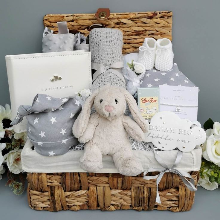 a basket filled with baby items including a stuffed bunny